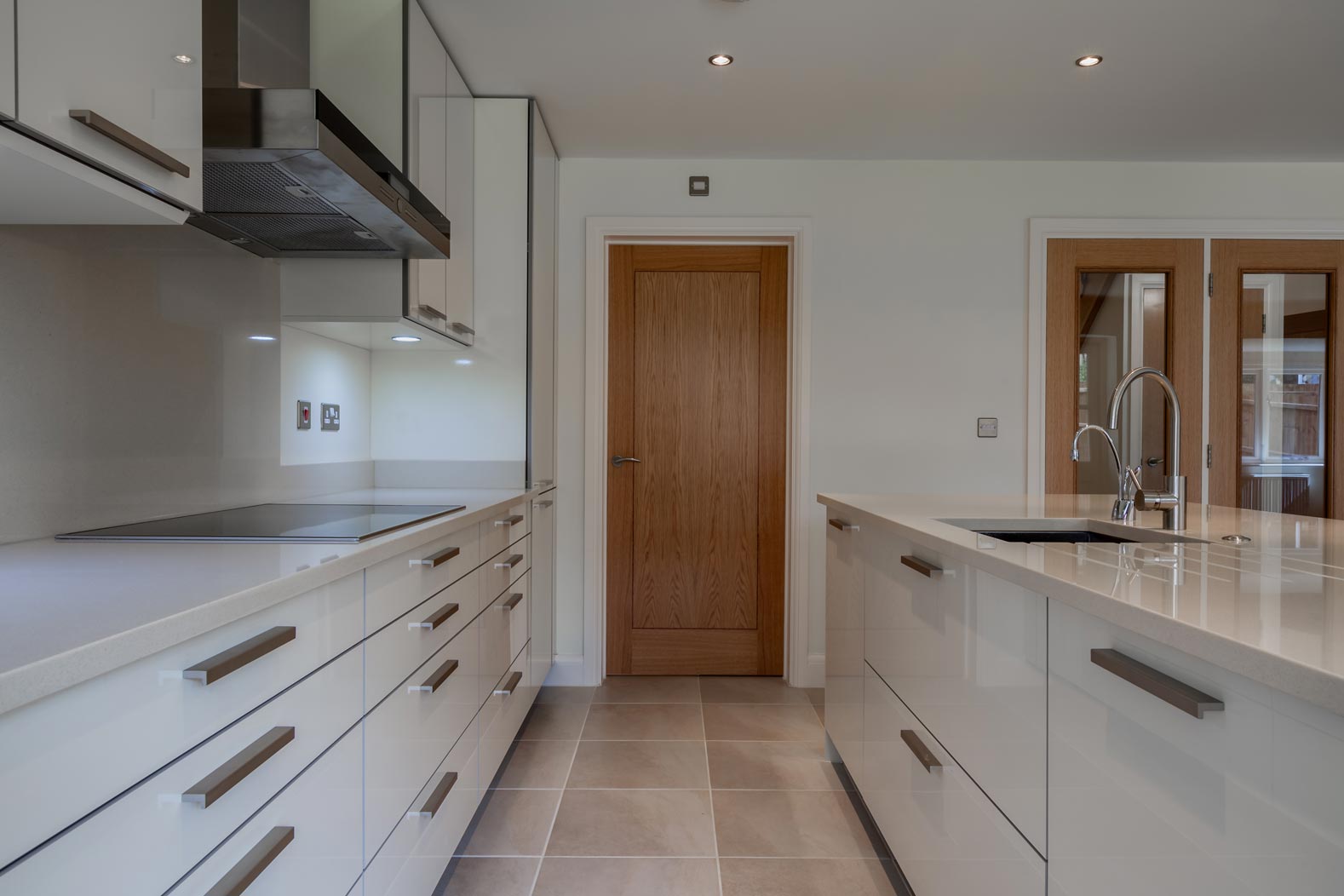 Modern kitchen design galley including fitted cupboards, numerous drawers