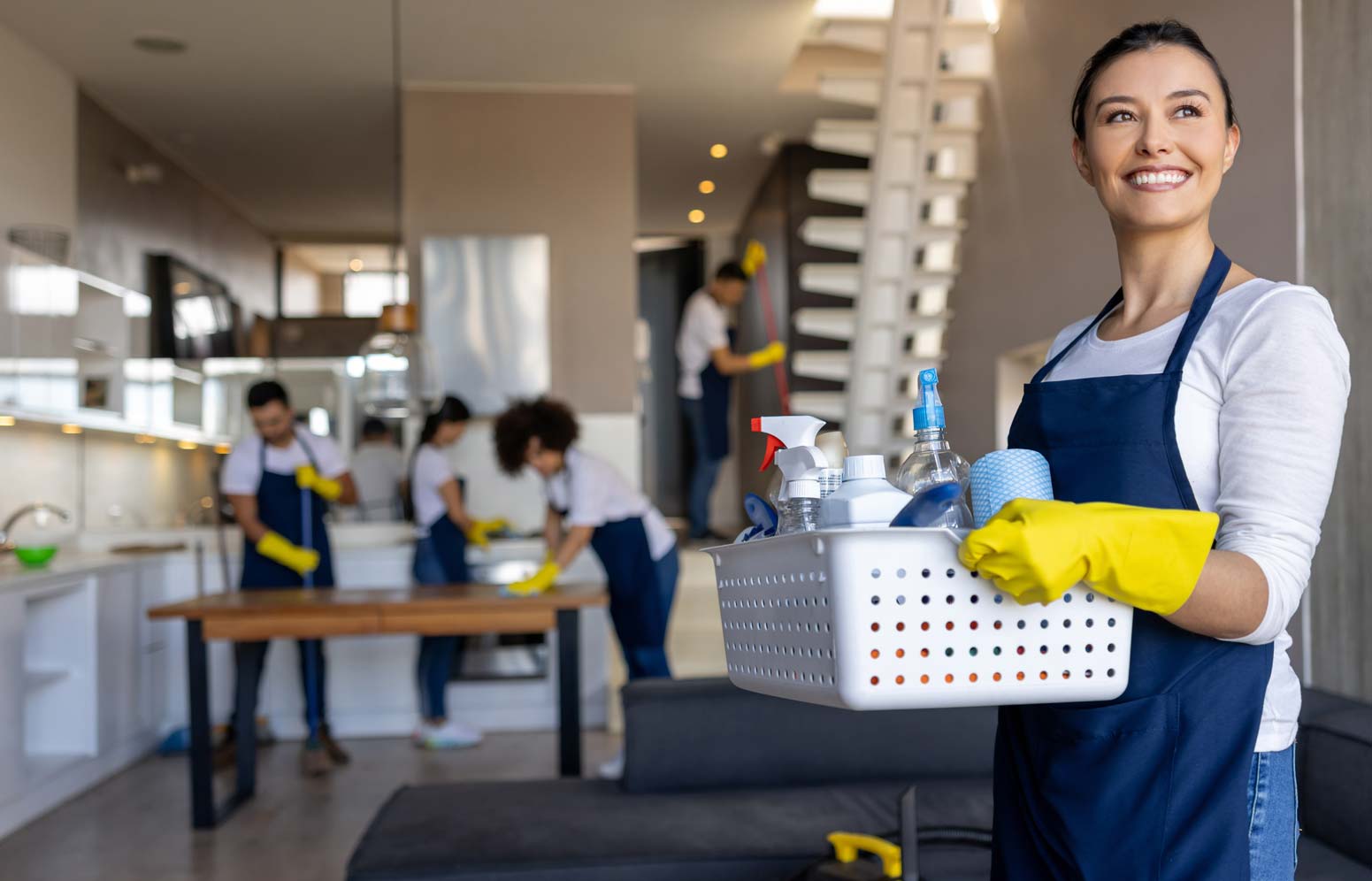 Professional cleaner working with her team cleaning a house
