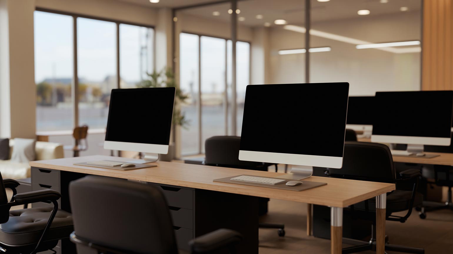Modern open office workspace with blank computer, desks, chairs, and natural light